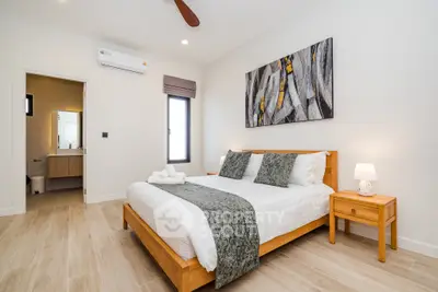 Modern bedroom with stylish decor and ensuite bathroom in a luxury apartment.