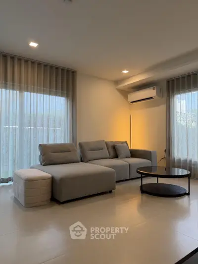 Modern living room with stylish gray sofa and elegant decor