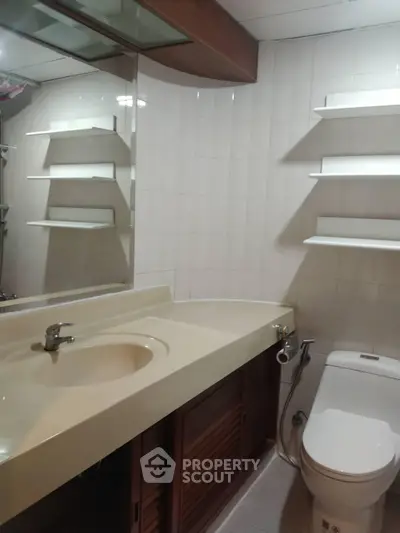 Modern bathroom with sleek fixtures and ample storage space
