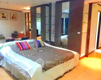 Luxurious bedroom with mirrored wardrobe and vibrant decor in modern apartment