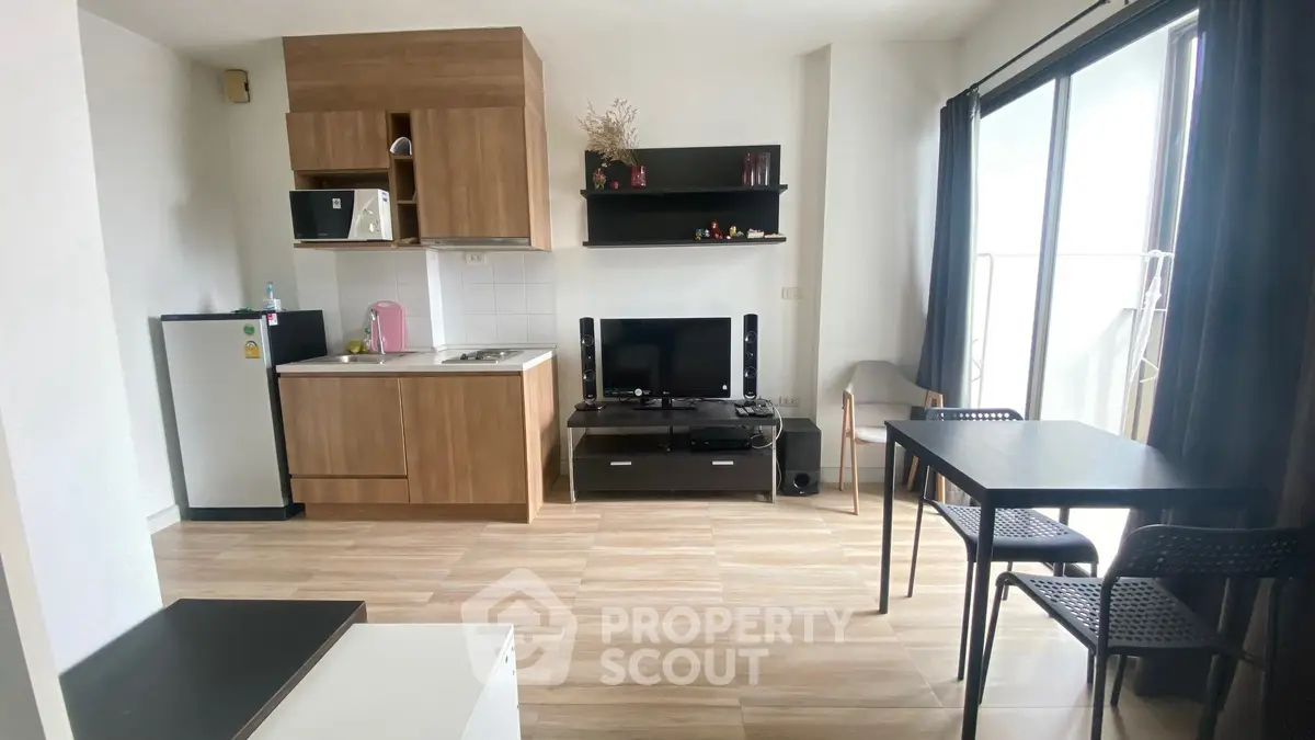 Modern studio apartment with kitchenette, dining area, and balcony access.