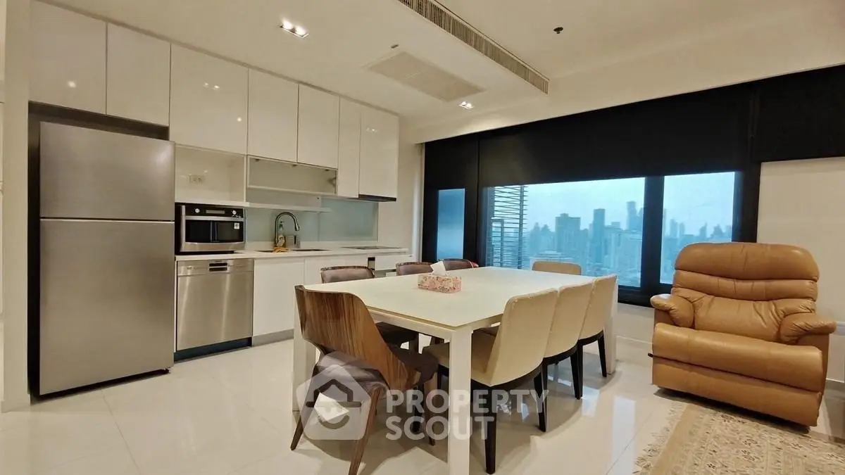 Modern kitchen with dining area and city view, featuring sleek appliances and comfortable seating.