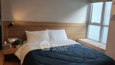 Cozy bedroom with large window and modern decor