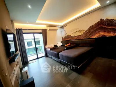 Luxurious bedroom with modern design and large windows offering natural light.