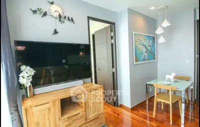 Charming living room with modern decor, wooden flooring, and stylish furniture, perfect for cozy living.