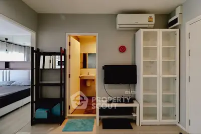 Modern apartment interior with bedroom, living area, and bathroom access.