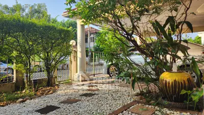 Charming garden entrance with lush greenery and decorative pathway