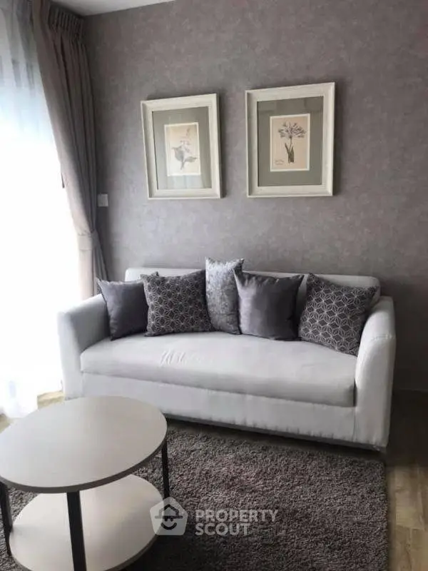 Cozy living room with elegant sofa and stylish decor in modern apartment.