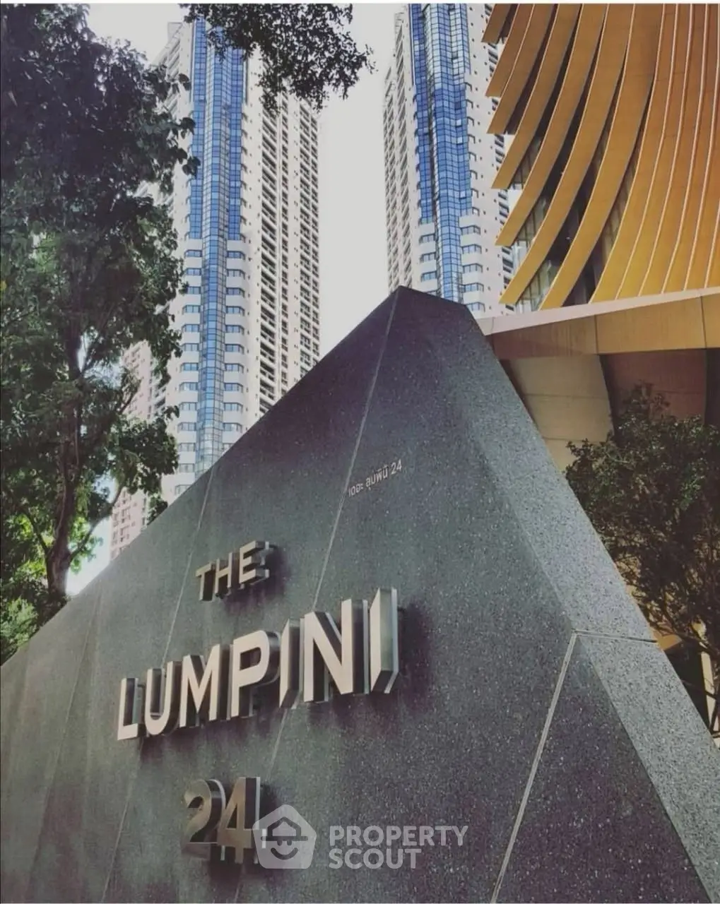 Modern high-rise building exterior with unique architectural design at The Lumpini 24.