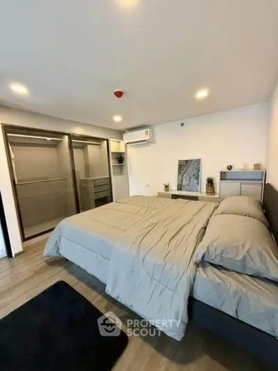 Spacious modern bedroom with stylish decor and ample closet space
