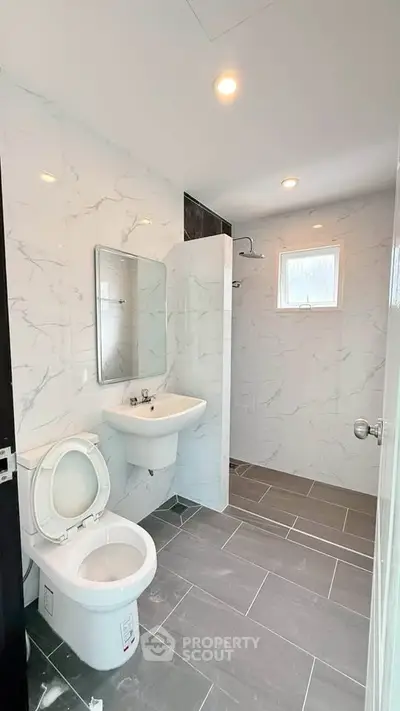 Modern bathroom with sleek marble tiles and contemporary fixtures