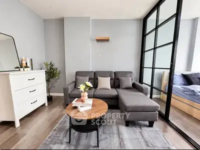 Modern living room with sleek gray sofa and stylish decor