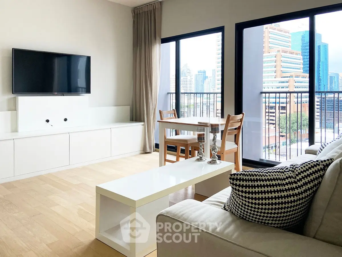 Modern living room with city view, sleek furniture, and natural light.