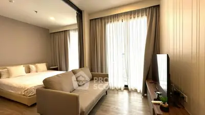 Modern studio apartment with cozy living area and natural light