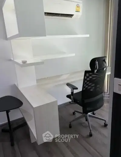Modern home office with sleek desk, ergonomic chair, and air conditioning for comfort.