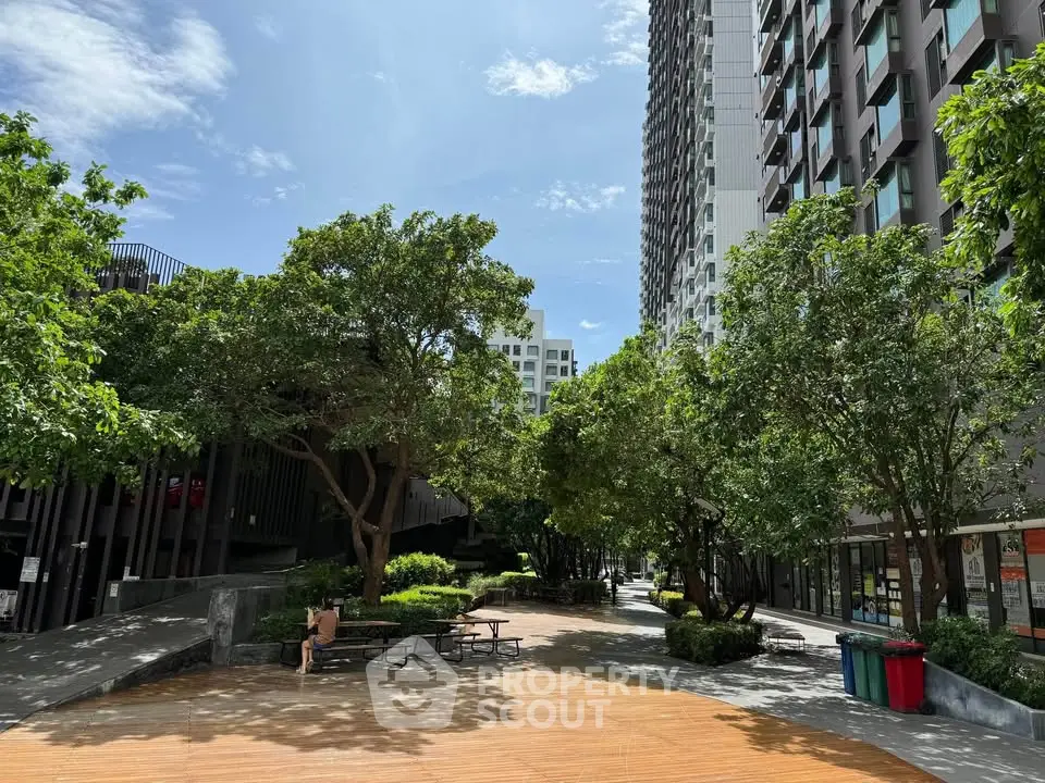 Modern residential building with lush garden and outdoor seating area
