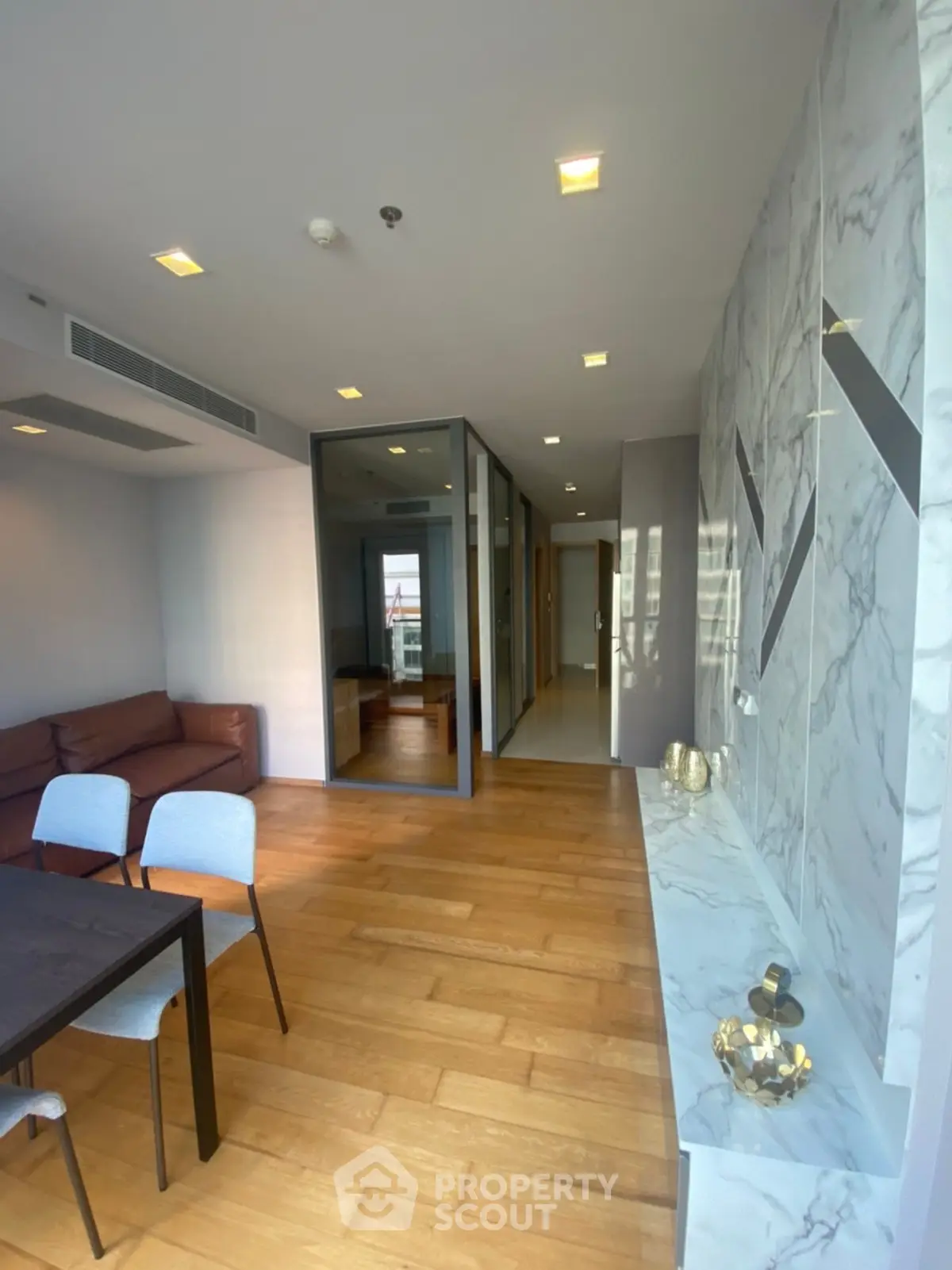 Modern living room with marble accents and wooden flooring