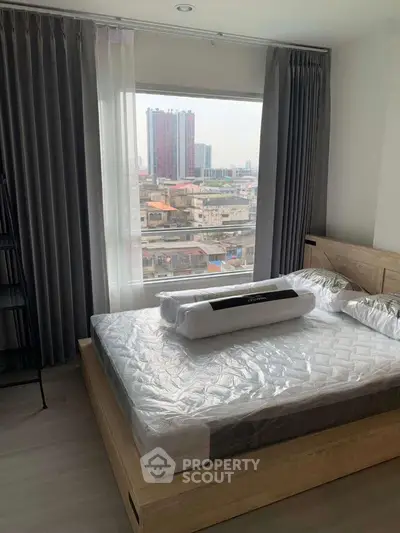 Modern bedroom with city view, featuring a stylish bed and floor-to-ceiling windows.