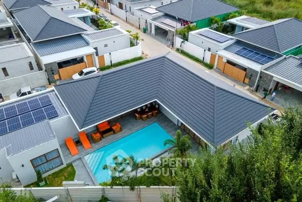 Luxurious modern villa with private pool and solar panels in a serene neighborhood.