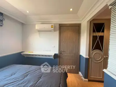 Cozy bedroom with modern design, featuring built-in closet and air conditioning for comfort.