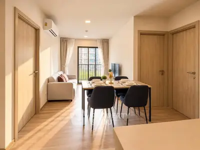 Modern living room with dining area and balcony view in a bright apartment