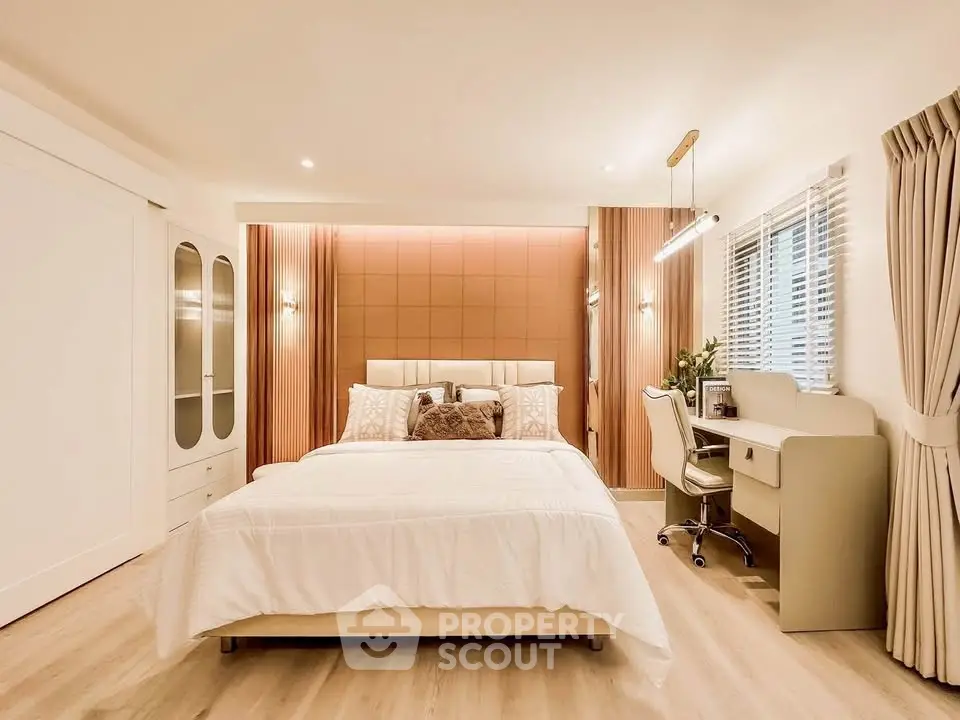 Luxurious bedroom with elegant decor and study area, featuring soft lighting and modern furnishings.