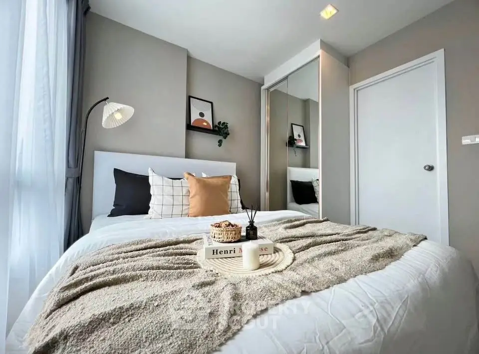 Cozy modern bedroom with stylish decor and ample natural light