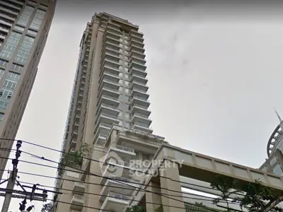 Stunning high-rise building with modern architecture and spacious balconies in urban setting.