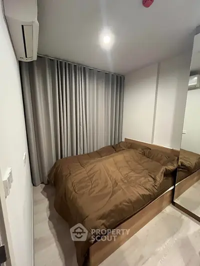 Cozy modern bedroom with brown bedding and mirrored wardrobe
