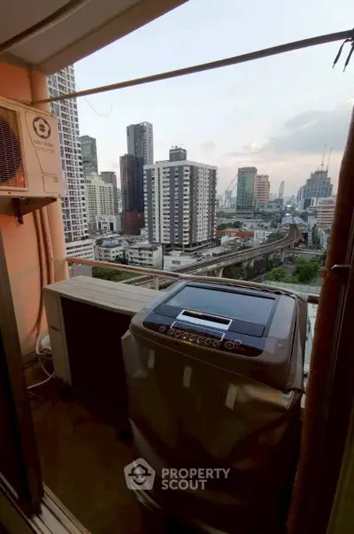 High-rise balcony with washing machine and stunning cityscape view