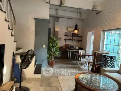 Chic industrial-style living room with open kitchen and modern decor