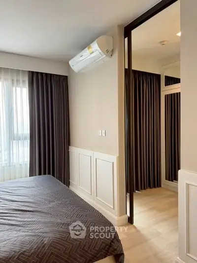 Modern bedroom with air conditioning and elegant curtains in a stylish apartment.