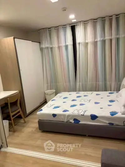 Cozy bedroom with stylish decor and ample natural light