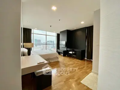 Spacious modern bedroom with city view and elegant wooden flooring