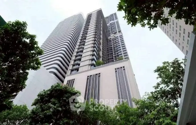 Stunning modern high-rise building with lush greenery and unique architectural design.