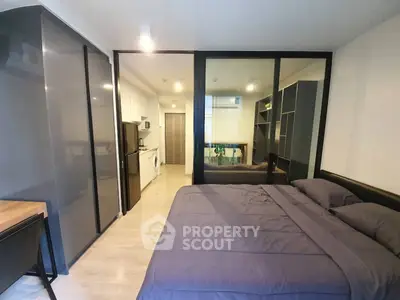 Modern studio apartment with sleek design and mirrored wardrobe