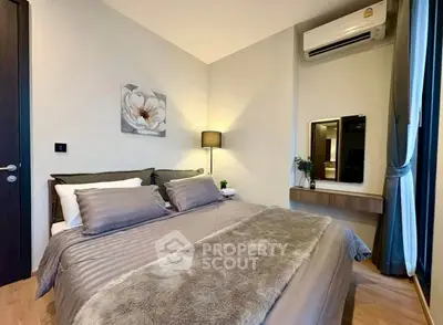Modern bedroom with cozy decor and air conditioning in a stylish apartment.
