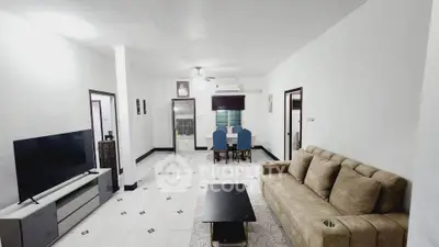 Spacious living room with modern decor and elegant dining area