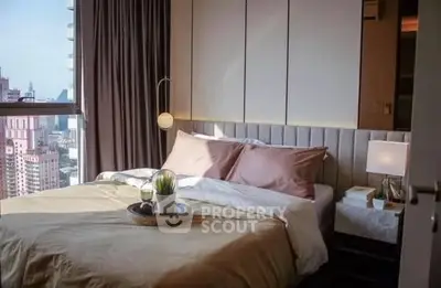 Luxurious bedroom with city view, elegant decor, and natural light in modern apartment.