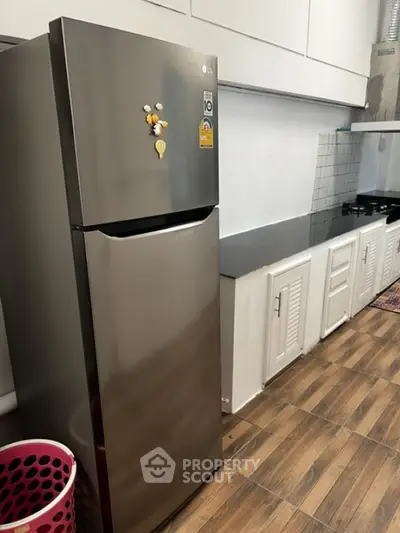 Modern kitchen with sleek fridge and spacious countertop