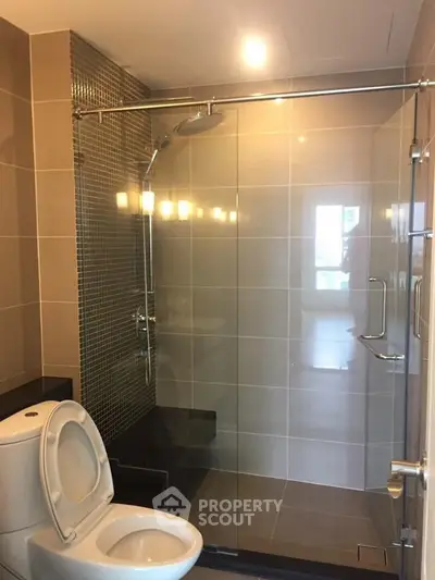 Modern bathroom with glass shower enclosure and sleek tile design