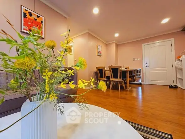 Spacious living room with elegant decor and wooden flooring, perfect for modern living.