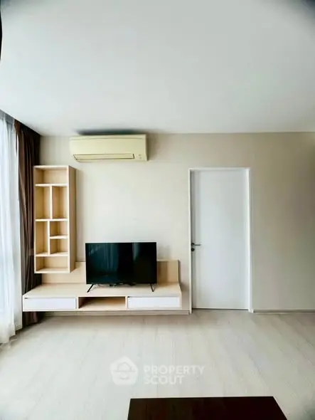 Modern living room with sleek TV unit and air conditioning