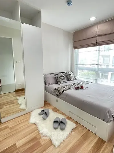 Modern bedroom with cozy decor and large window view