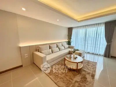 Spacious modern living room with large sofa and natural light