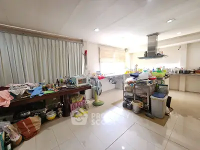 Spacious kitchen with open layout and ample natural light, featuring modern appliances and tiled flooring.