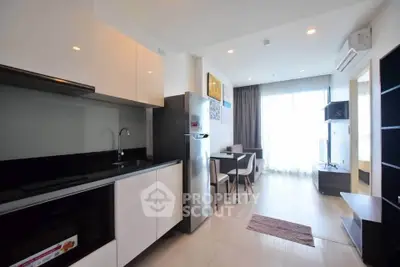 Modern open-plan kitchen and living area with sleek design and natural light.