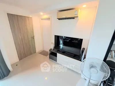 Modern living room with sleek TV setup and air conditioning