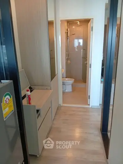 Compact modern bathroom with sleek design and wooden flooring