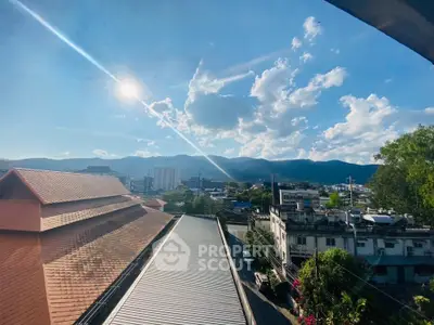 Stunning cityscape view with mountains and clear blue sky, perfect for urban living.